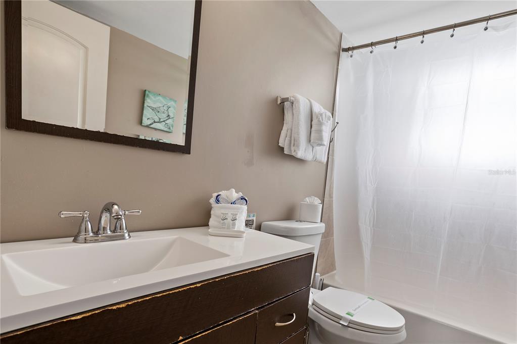 2749 North Poinciana Boulevard, Unit 15 Kissimmee, FL 34746 - Photo 16 of 36 a bathroom with a sink toilet and shower