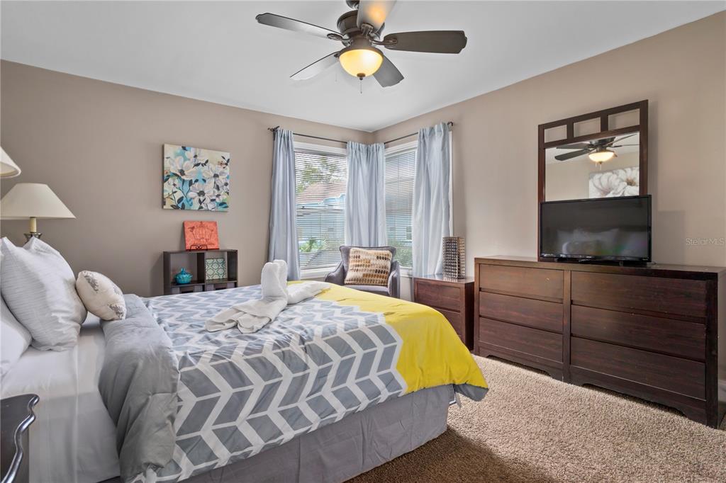 2749 North Poinciana Boulevard, Unit 15 Kissimmee, FL 34746 - Photo 19 of 36 a bedroom with a bed and a flat screen tv