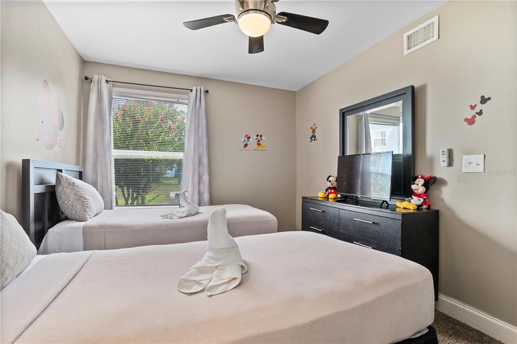 2749 North Poinciana Boulevard, Unit 15 Kissimmee, FL 34746 - Photo 26 of 36 a living room with furniture and a flat screen tv