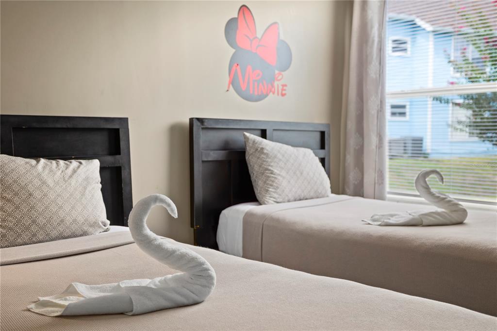 2749 North Poinciana Boulevard, Unit 15 Kissimmee, FL 34746 - Photo 27 of 36 a bedroom with a bed and wooden floor