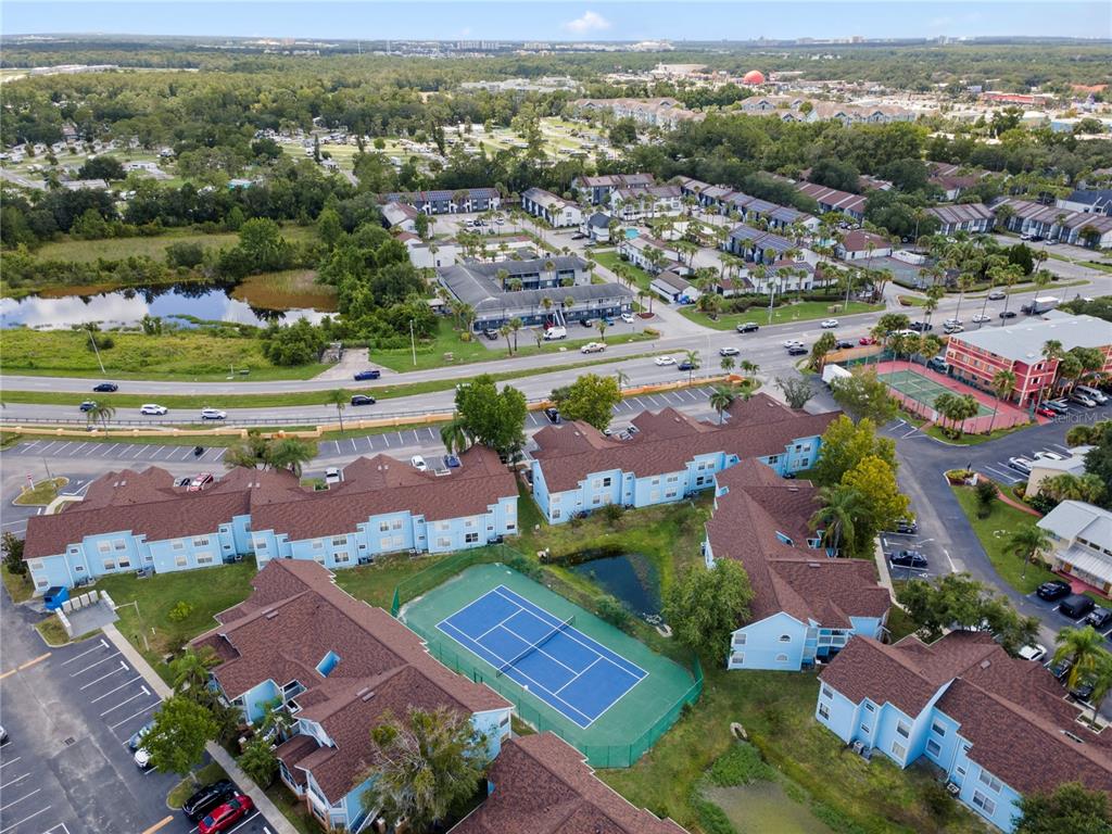2749 North Poinciana Boulevard, Unit 15 Kissimmee, FL 34746 - Photo 35 of 36 an aerial view of a city with lots of residential buildings ocean and mountain view