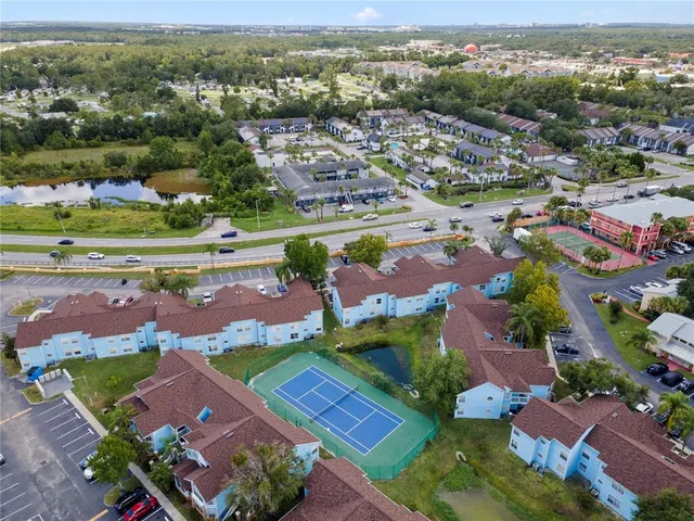 an aerial view of a city with lots of residential buildings ocean and mountain view