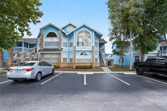 a car parked in front of a white house