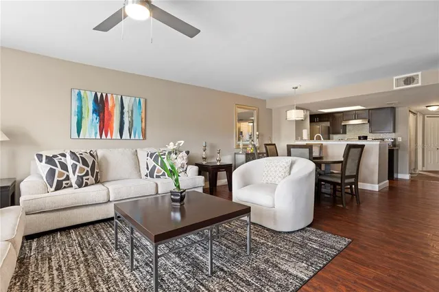 a living room with furniture a rug and a table