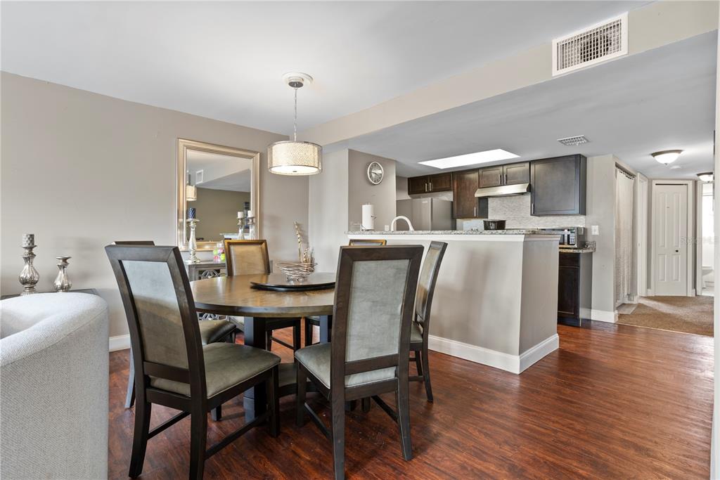 2749 North Poinciana Boulevard, Unit 15 Kissimmee, FL 34746 - Photo 8 of 36 a view of a dining room with furniture and wooden floor