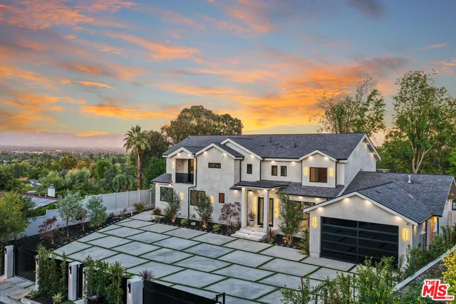 a view of a swimming pool with lawn chairs under an umbrella