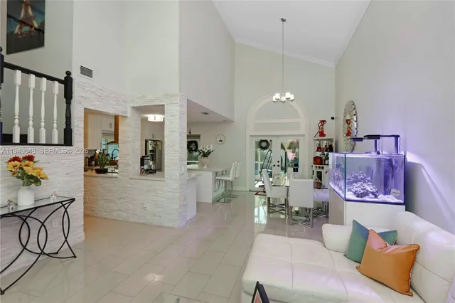 a living room with furniture and kitchen view