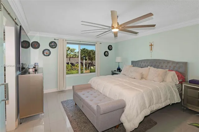 a bedroom with a large bed and a chandelier