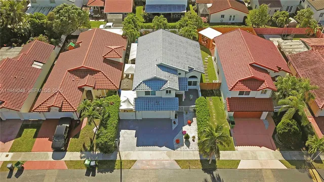 an aerial view of houses with yard