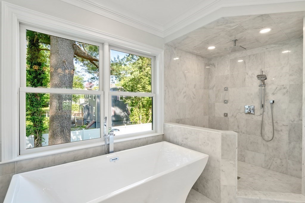 30 Asheville Road Newton, MA 02462 - Photo 12 of 16 a white bath tub sitting in a bathroom next to a window