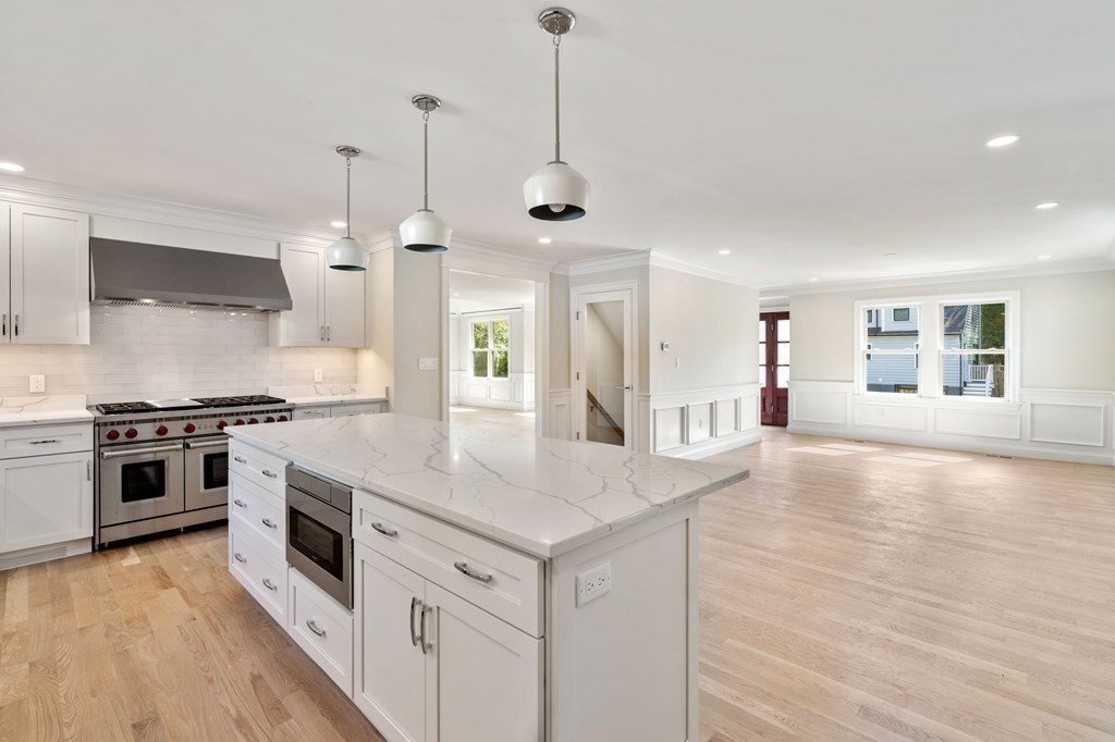 30 Asheville Road Newton, MA 02462 - Photo 4 of 16 a kitchen with stainless steel appliances granite countertop a stove and a kitchen island