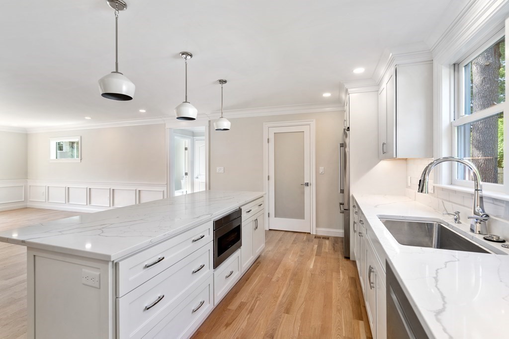 30 Asheville Road Newton, MA 02462 - Photo 5 of 16 a kitchen with stainless steel appliances granite countertop a sink stove and wooden floor