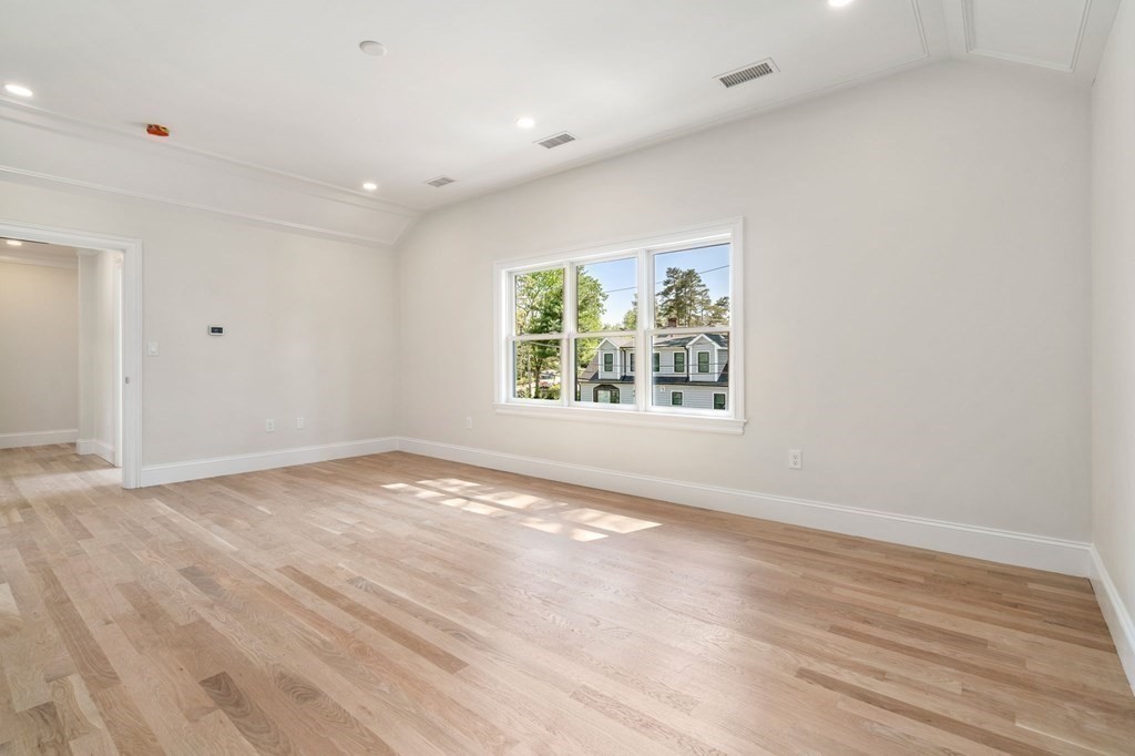 30 Asheville Road Newton, MA 02462 - Photo 10 of 16 an empty room with wooden floor and windows