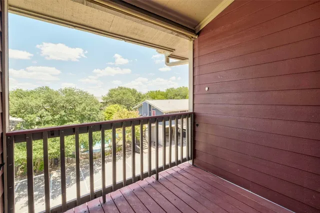 a view of a balcony with wooden floor