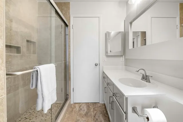 a bedroom with a bed a dresser and a window