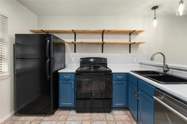a kitchen with a refrigerator and a sink