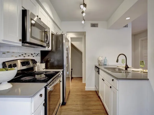 a kitchen that has a lot of cabinets in it
