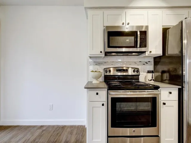 a view of kitchen with sink and wooden floor