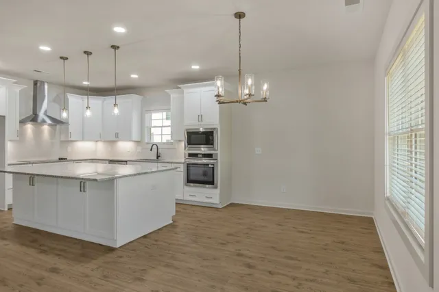 a large white kitchen with a window