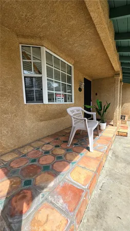 a view of a hallway with a window and a flat screen tv