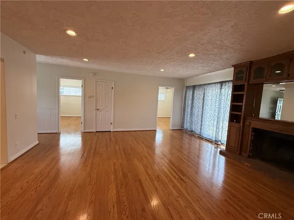 an empty room with wooden floor and closet