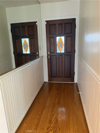a view of an empty room and wooden floor
