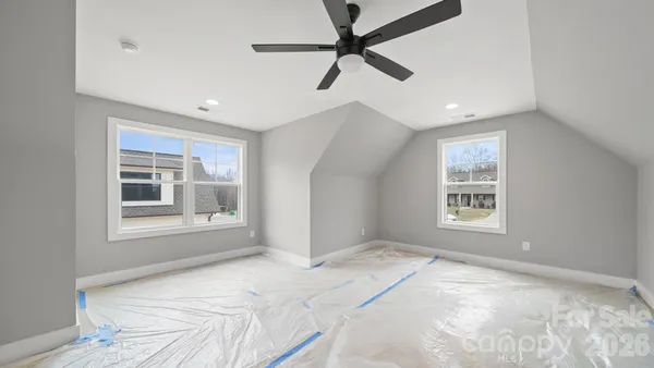 a view of a bedroom with a bed and a window