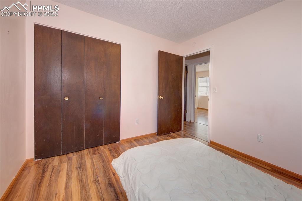 369 G Street Penrose, CO 81240 - Photo 18 of 37 a bedroom with a bed and a mirror