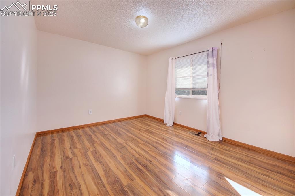 369 G Street Penrose, CO 81240 - Photo 20 of 37 an empty room with wooden floor closet and windows