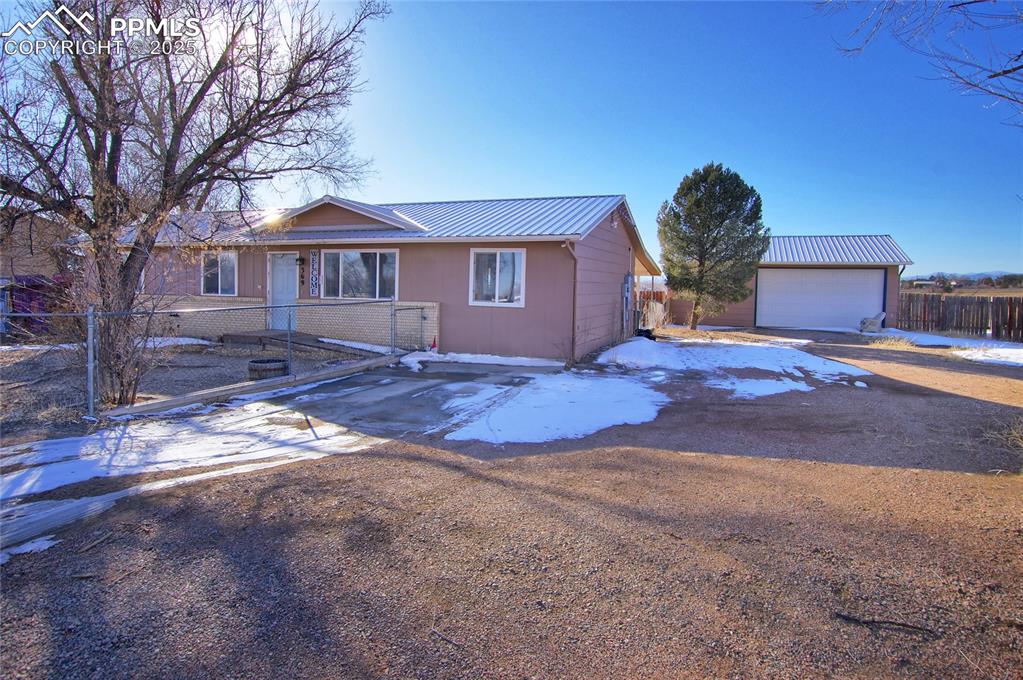 369 G Street Penrose, CO 81240 - Photo 5 of 37 a front view of a house with yard and trees