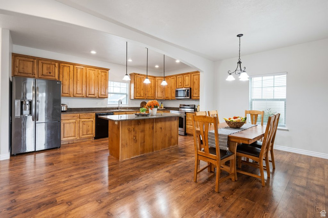 2029 West Crescent Row Mapleton, UT 84664 - Photo 13 of 35 Open concept kitchen and dining area with wood-finish flooring, wood cabinetry, stone countertops, and recessed lighting