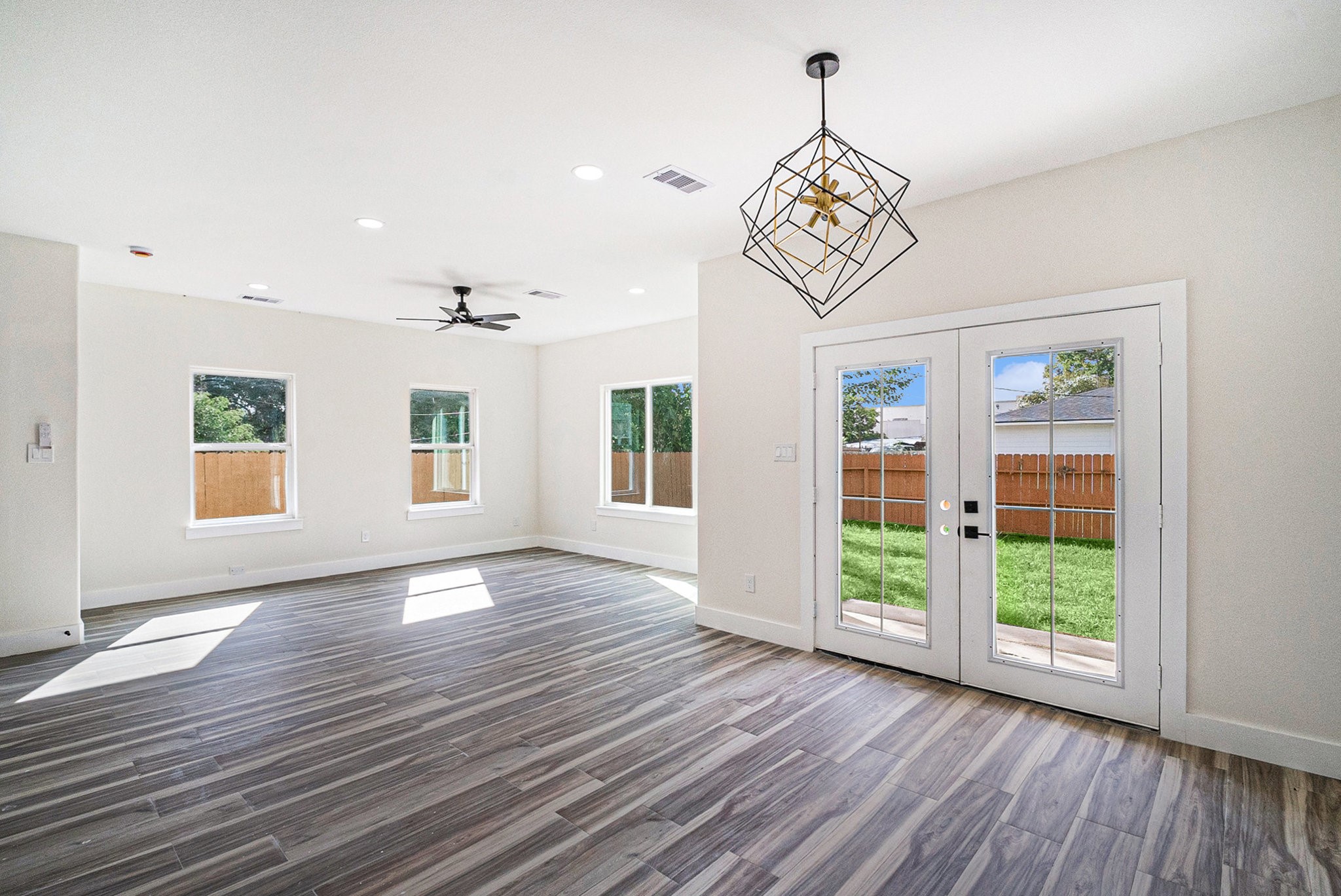 9807 Bamboo Road, Unit A Houston, TX 77041 - Photo 15 of 37 a view of an empty room with wooden floor and a window