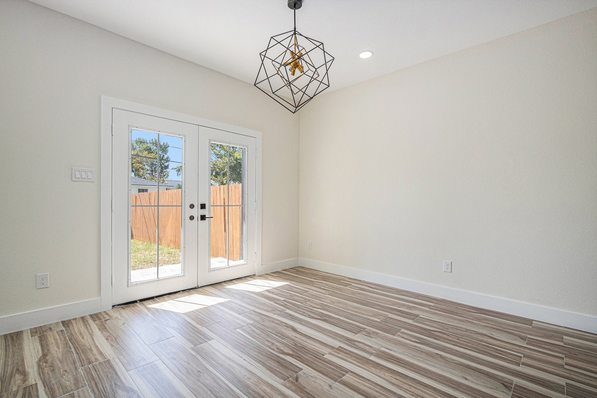 9807 Bamboo Road, Unit A Houston, TX 77041 - Photo 26 of 37 a view of an empty room with wooden floor and a window