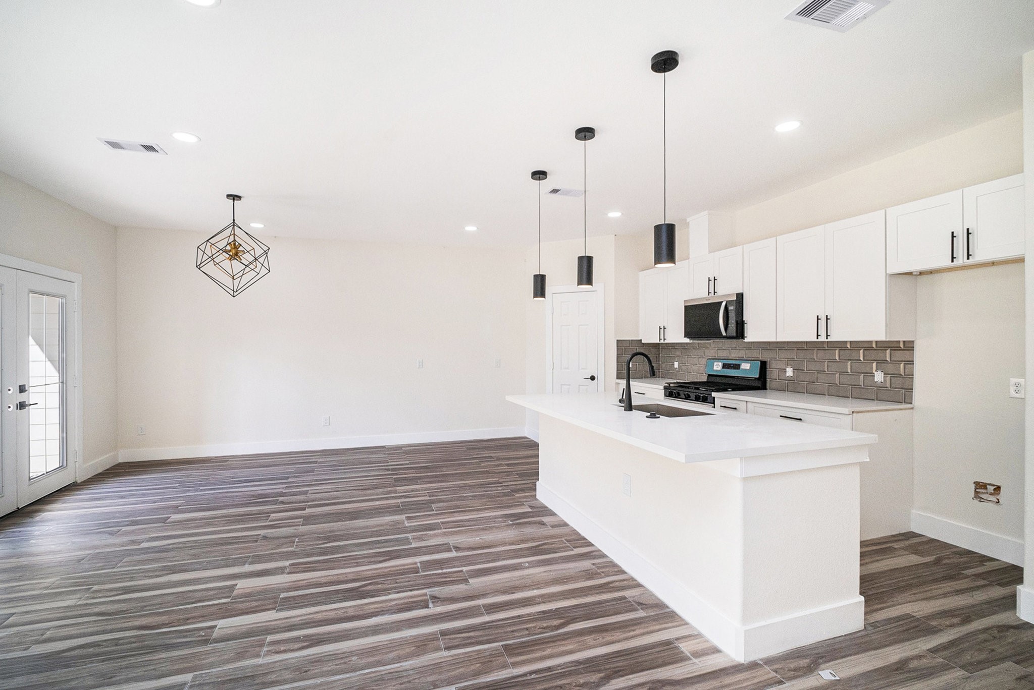 9807 Bamboo Road, Unit A Houston, TX 77041 - Photo 6 of 37 a kitchen with kitchen island a white counter top space cabinets and stainless steel appliances