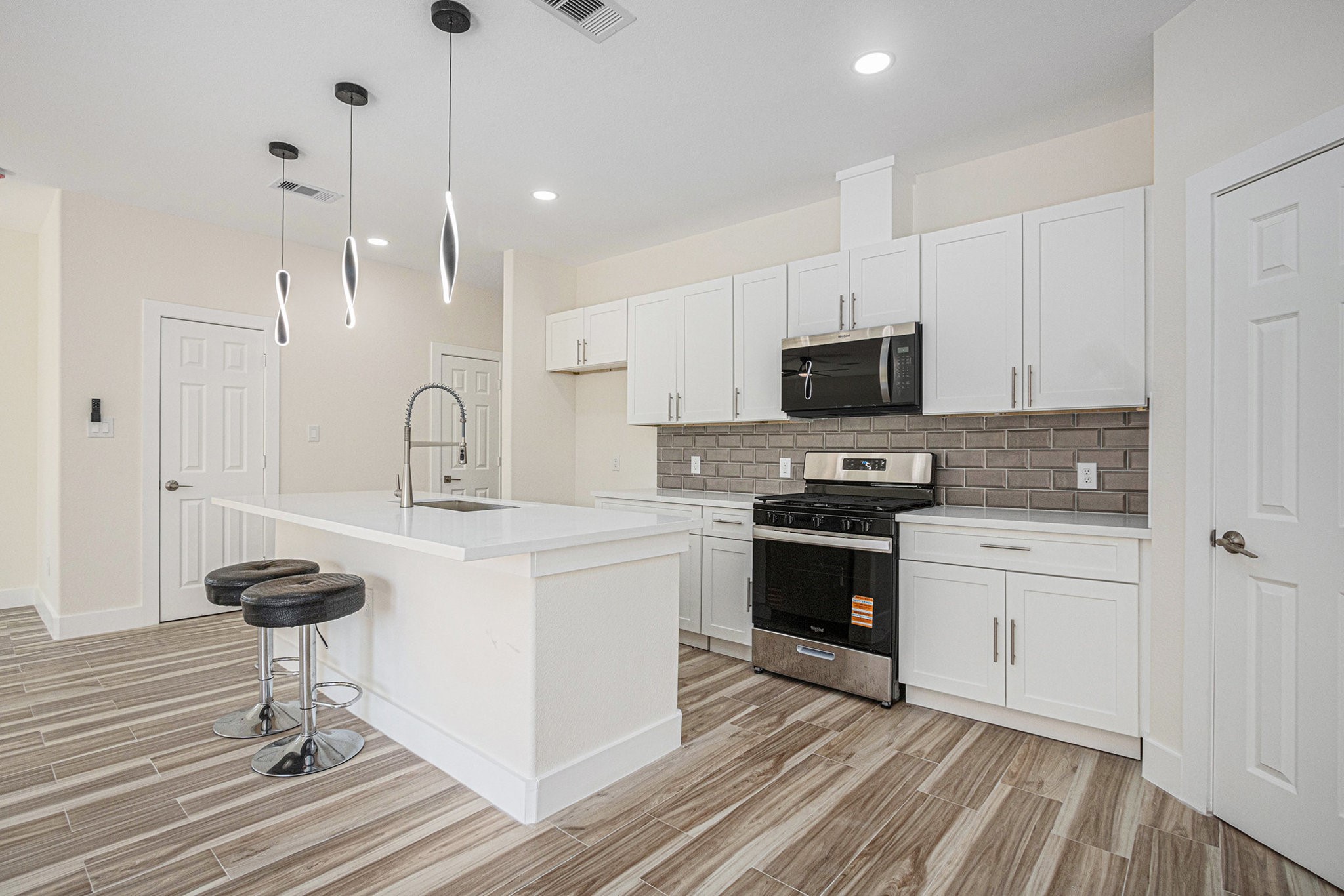 9807 Bamboo Road, Unit A Houston, TX 77041 - Photo 7 of 37 a kitchen with granite countertop a stove a sink and a refrigerator