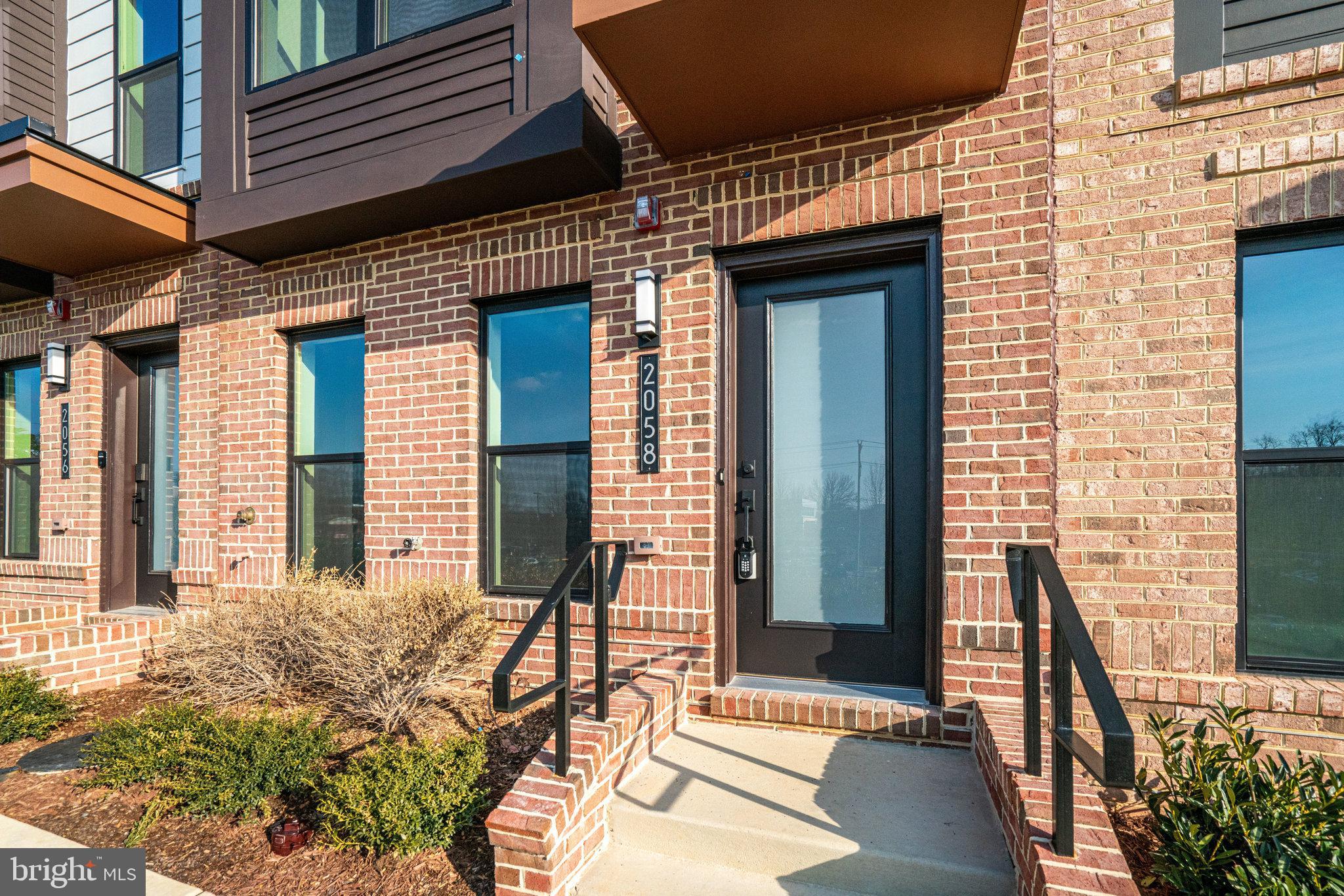 a view of a patio with a table and chairs and floor to ceiling window and stairs