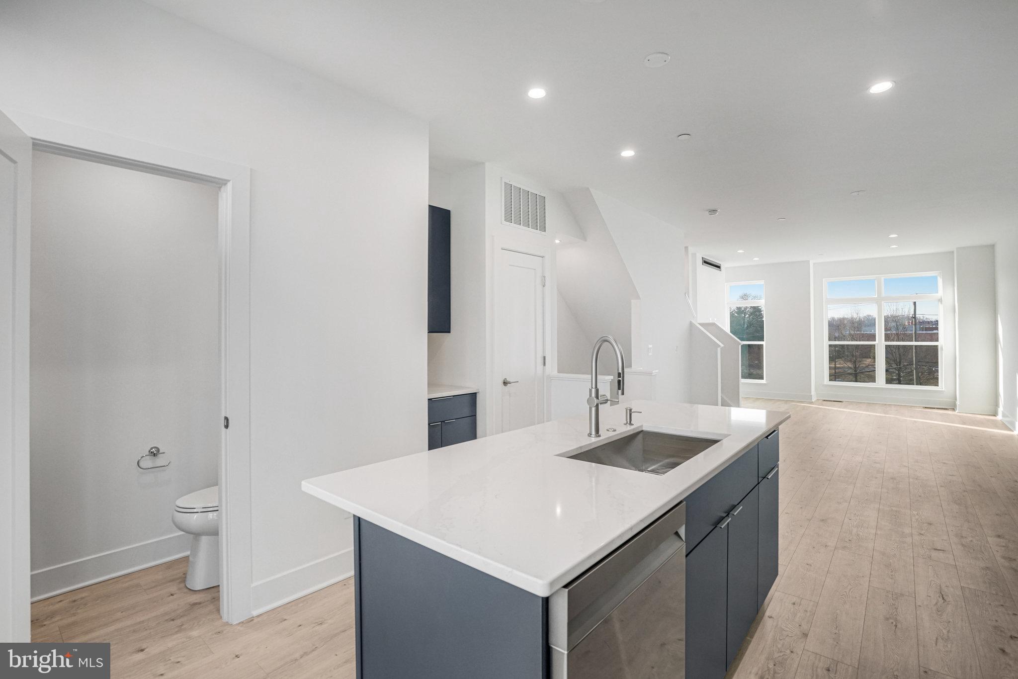 2058 Tysons Ridgeline Road Falls Church, VA 22043 - Photo 11 of 48 a bathroom with a granite countertop sink a toilet a large mirror and shower