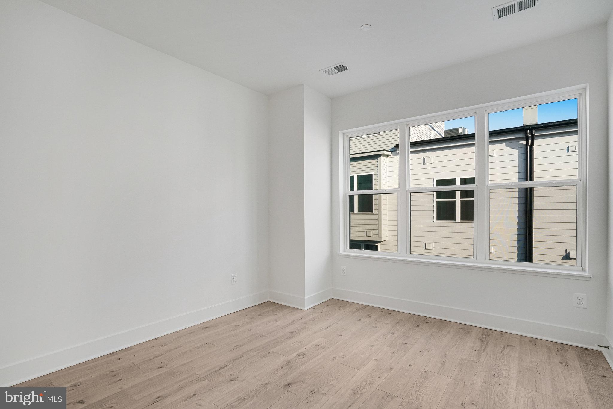 2058 Tysons Ridgeline Road Falls Church, VA 22043 - Photo 21 of 48 an empty room with wooden floor and windows