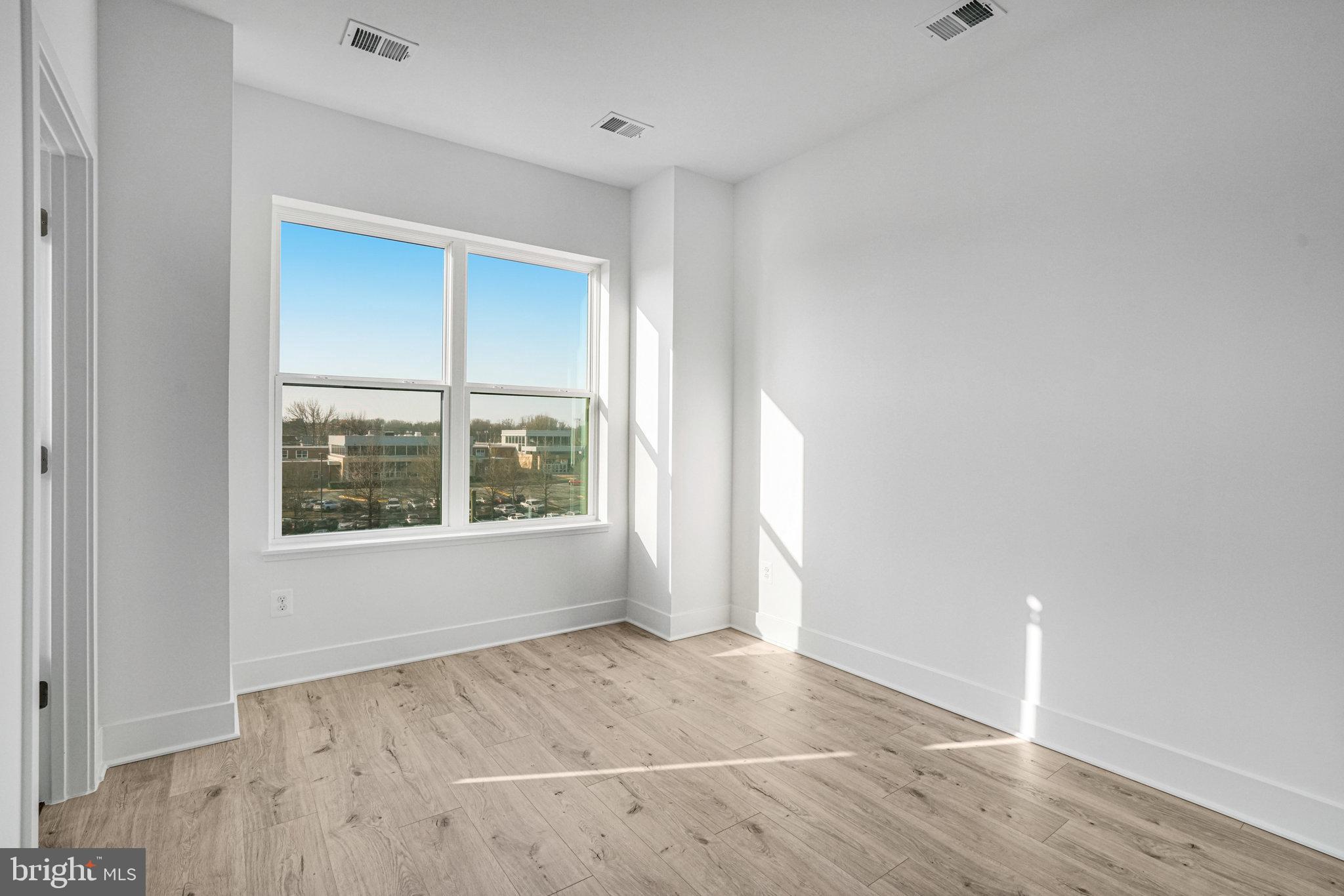 2058 Tysons Ridgeline Road Falls Church, VA 22043 - Photo 25 of 48 an empty room with wooden floor and windows