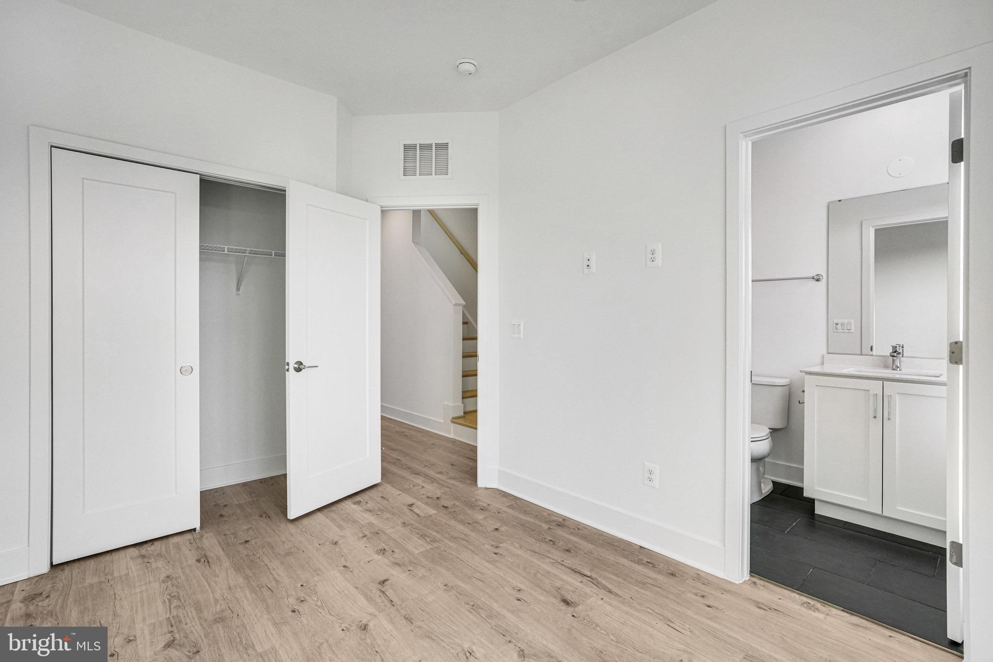 2058 Tysons Ridgeline Road Falls Church, VA 22043 - Photo 26 of 48 an empty room with wooden floor and closet