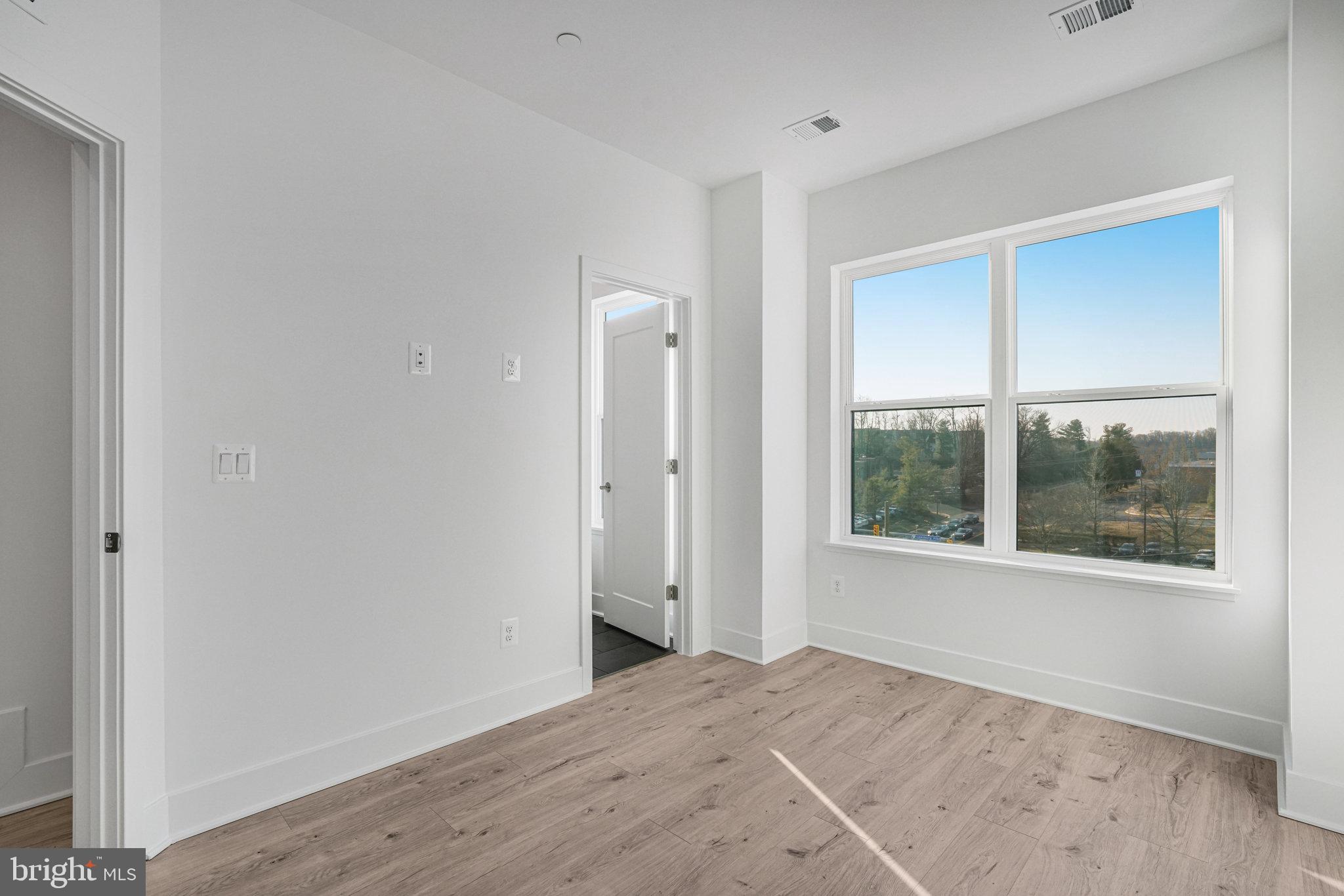 2058 Tysons Ridgeline Road Falls Church, VA 22043 - Photo 27 of 48 an empty room with a window and a wooden floor