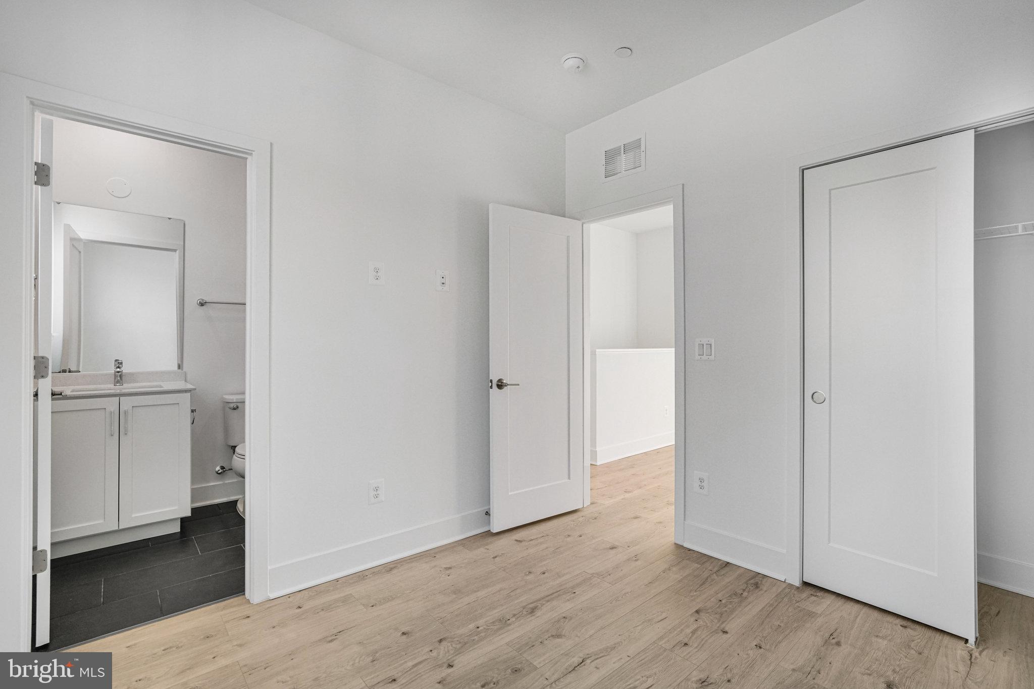 2058 Tysons Ridgeline Road Falls Church, VA 22043 - Photo 35 of 48 a view of an empty room with closet and wooden floor