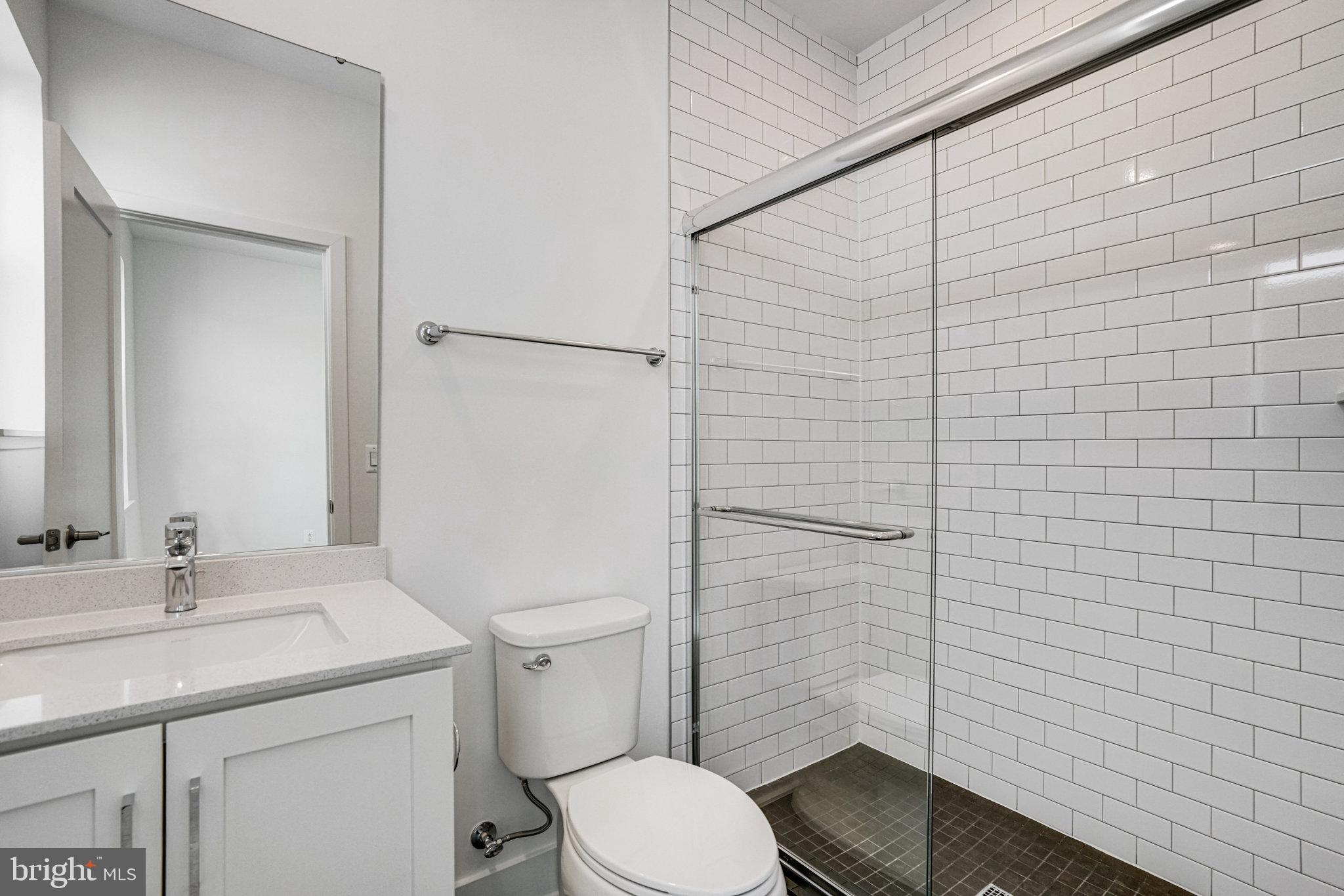 2058 Tysons Ridgeline Road Falls Church, VA 22043 - Photo 36 of 48 a bathroom with a sink a toilet and shower