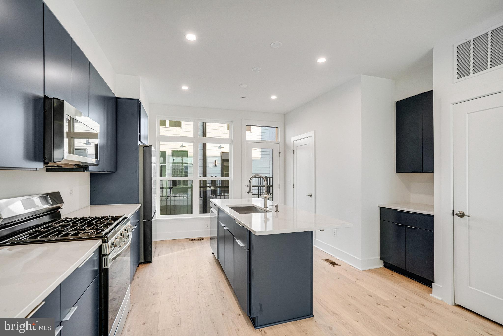 2058 Tysons Ridgeline Road Falls Church, VA 22043 - Photo 6 of 48 a large kitchen with stainless steel appliances granite countertop a stove and a sink
