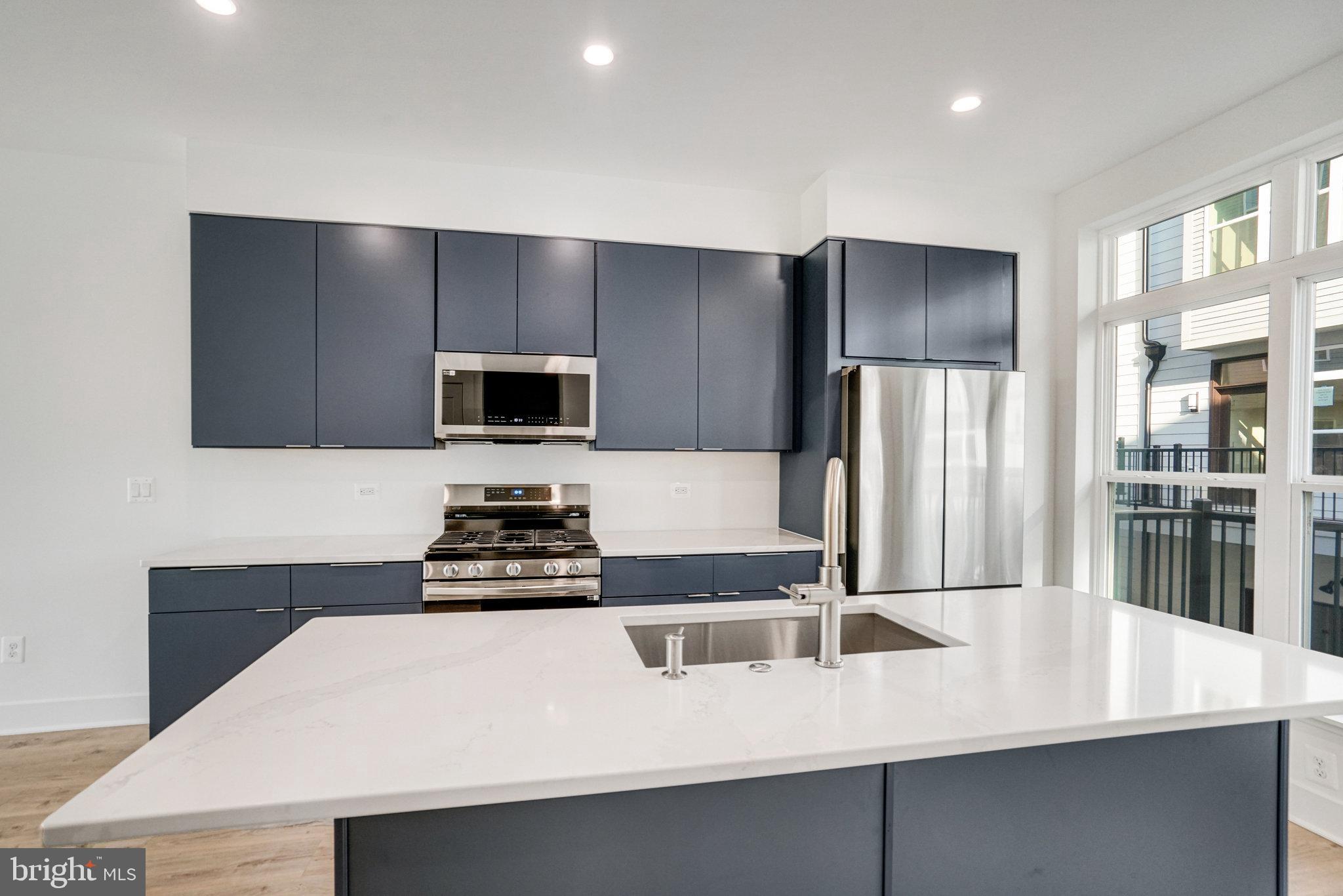 2058 Tysons Ridgeline Road Falls Church, VA 22043 - Photo 9 of 48 a kitchen with stainless steel appliances a microwave a stove and refrigerator