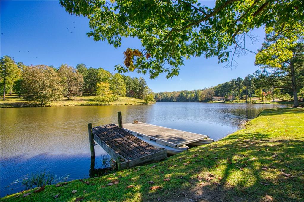 1709 4 Notch Road Carrollton, GA 30116 - Photo 1 of 1 a view of a lake with houses in the back