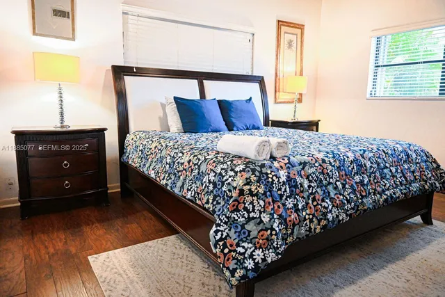 a bedroom with a bed and a night stand