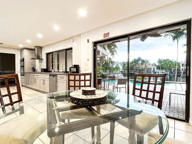 a living room with couches a dining table and chairs with kitchen view