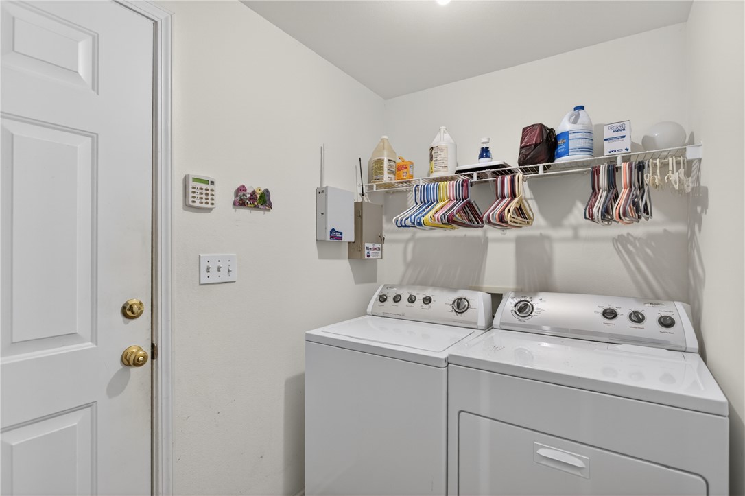 207 Hunters Lane Anderson, SC 29625 - Photo 29 of 46 Functional laundry space featuring a practical wire shelf and essential appliances for effortless utility. The laundry room connects the garage and the kitchen.