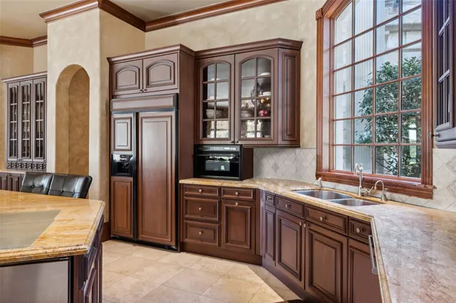 a kitchen with a sink stove and cabinets